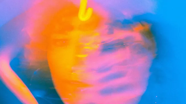 Abstract, kleurrijk portret met oranje, roze en blauw. Een gezicht is vaag te zien.