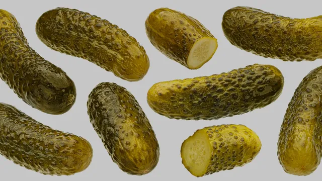 Marinated cucumbers, pickled gherkins isolated on white background