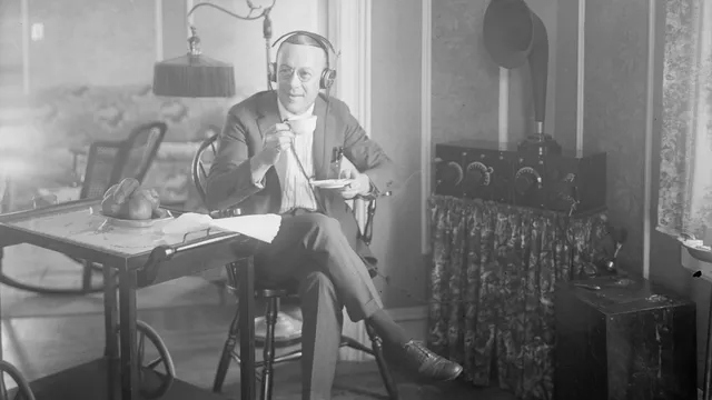 Ernest Hare, US star of Vaudeville, phonograph records, and radio, listens to the radio with headphones. Circa 1921-1925. Bain News Service photograph via Library of Congress website.