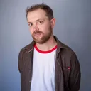 Man met baard kijkt in camera