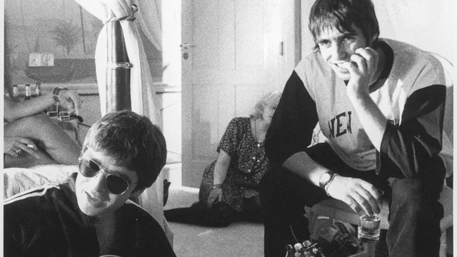Musician Noel Gallagher (left) and brother Liam Gallagher of British indie rock band Oasis seen backstage on tour during the heydays of Brit-pop in the 1990s.