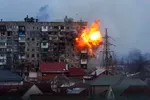 An apartment building explodes after a Russian army tank fires in Mariupol, Ukraine, Friday, March 11, 2022.
