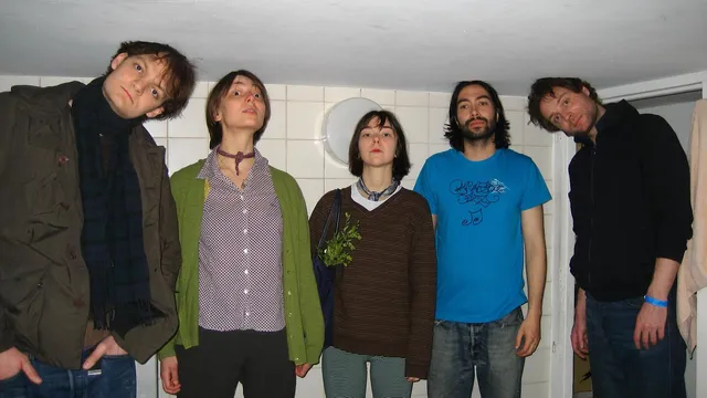 de hele band staat onder een laag plafond met hun hoofd schuin