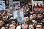 A participant holds up a sign depicting Slovakian Prime Minister Robert Fico wearing prison clothing near the Slovak National Uprising (SNP) square during a rally under the slogan "For a Decent Slovakia", against corruption and to pay tribute to murdered Slovak journalist Jan Kuciak and his fiancee Martina Kusnirova on March 16, 2018 in Bratislava, Slovakia. Organisers of the anti-government street protests this month continue to call for snap elections as well as a thorough and independent investigation of the journalist murder.